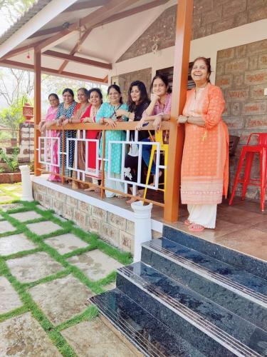 a group of women standing on a fence at Swaru Luxurious Villa in Tamhini Ghat & Kolad Rafting in Nizāmpur