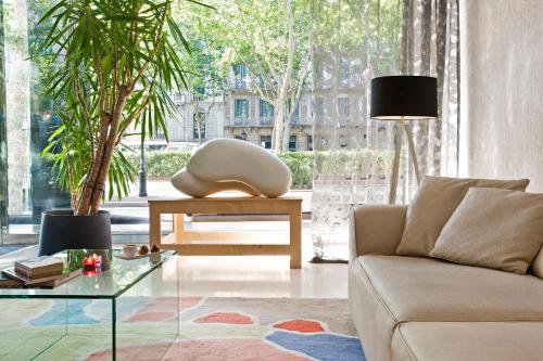 a living room with a couch and a table at Grupotel Gran Via 678 in Barcelona