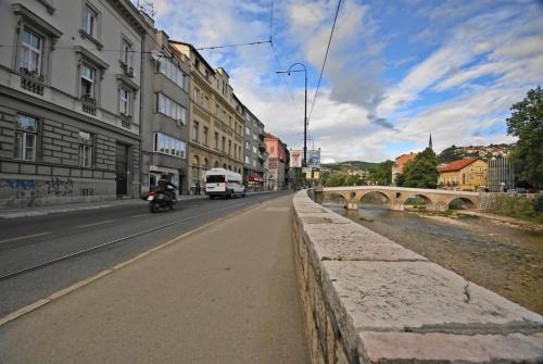 a city street with a bridge and cars on the road at Studio Park in Sarajevo