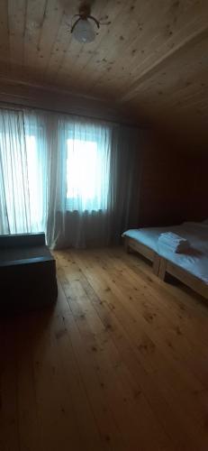 an empty room with a bed and a window at Біла хата in Iltsi