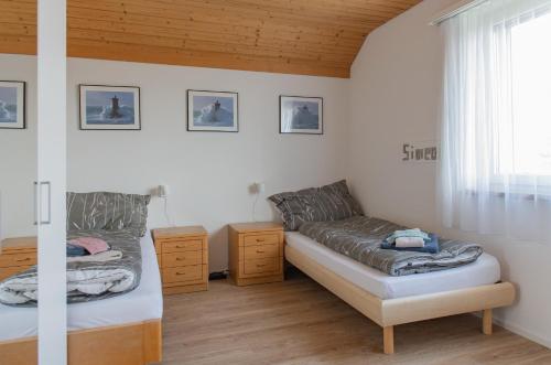a bedroom with a bed and a couch and a window at BnB Bergsicht in Dettighofen