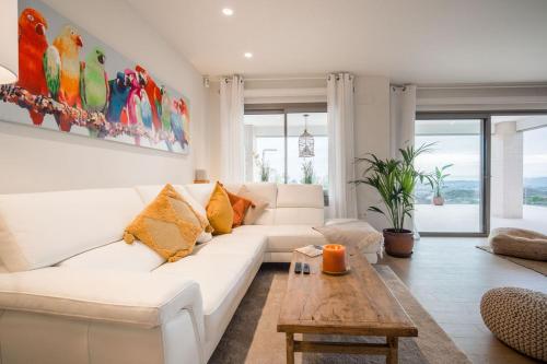 a living room with a white couch and a table at Casa Carolina - This One in Higuerón with Quality and Peace in Mijas