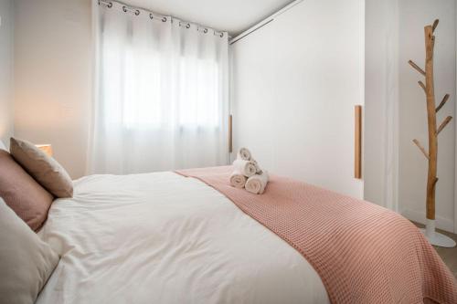 a bedroom with a bed with two stuffed animals on it at Casa Carolina - This One in Higuerón with Quality and Peace in Mijas