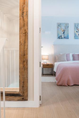 a bedroom with a bed and a mirror at Casa Carolina - This One in Higuerón with Quality and Peace in Mijas