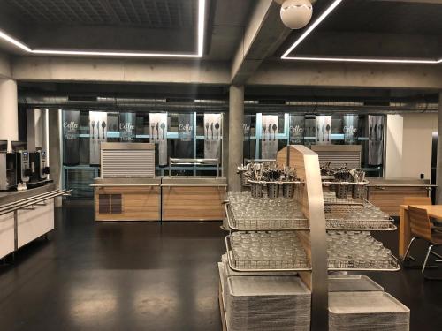 a large kitchen with many dishes on display at Geneva Hostel in Geneva