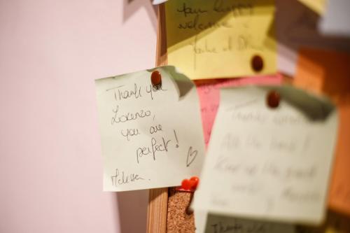 a piece of paper taped to a wall with notes at Etruria Airport in Pisa
