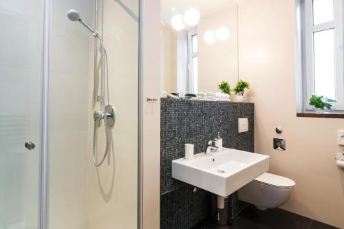 a bathroom with a sink and a shower at Prima Luxury Rooms in Split