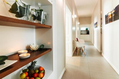a hallway with a bowl of fruit on a shelf at Prima Luxury Rooms in Split