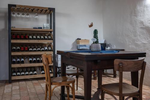 a room with a table and chairs and wine bottles at Tschardakenhof Appartements in Lutzmannsburg