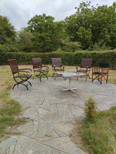 a group of benches sitting on a stone patio at Korta Escape- A Heritage Resort in Jawai in Korta