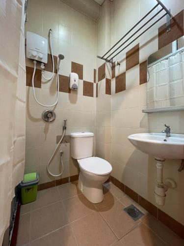 a bathroom with a toilet and a sink at Fresh Hotel Falim in Ipoh