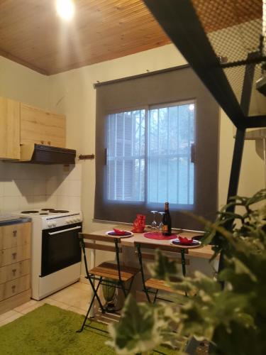a kitchen with a table with two chairs and a window at Country House in Sozopoli