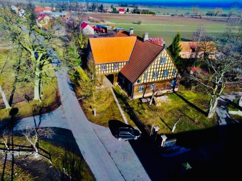 a large house with a car parked in front of it at Dom Podcieniowy na Żuławach Wiślanych in Nowy Dwór Gdański