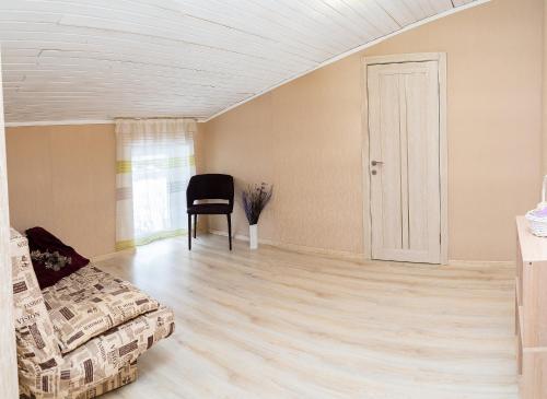 a living room with a couch and a chair at Апартаменти дворівневі на віллі с садом in Kyiv