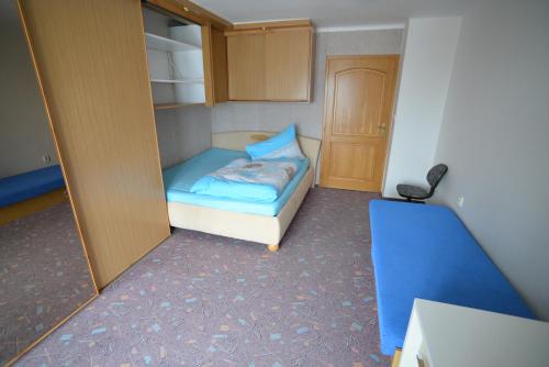 a small room with a small bed and a closet at Apartment near Lake in Pilsen in Plzeň