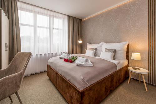 a hotel room with a bed with towels on it at Penzion ZENIT in Prešov