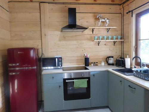 a kitchen with a red refrigerator and a sink at FoRest Inn in Trzepieciny
