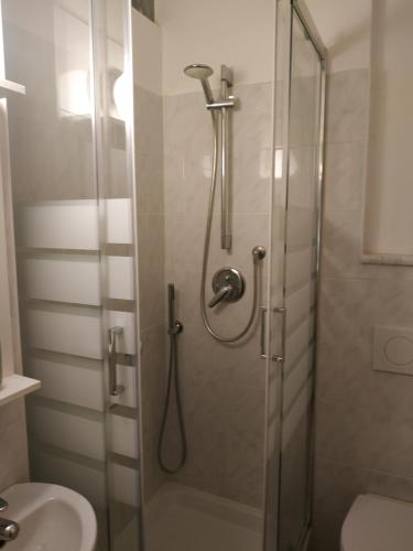 a bathroom with a shower with a toilet and a sink at Appartamento Aurora in Florence