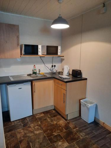 a kitchen with a sink and a counter top at The Townhouse Self Catering in Dumfries