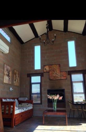 a living room with a brick wall with a fireplace at The love bubble in Lutzville