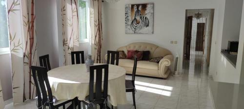 a living room with a table and a couch at Edelweis in Sainte-Luce