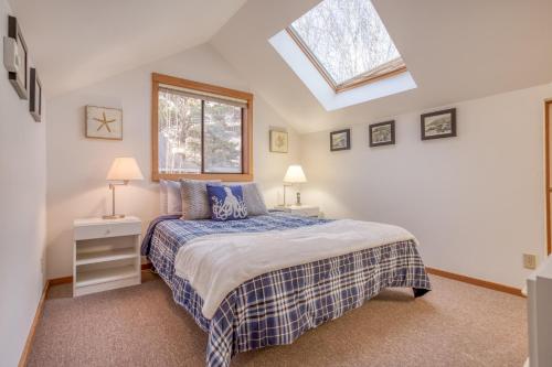 a bedroom with a bed and a skylight at Driftwood Cottage MCA 491 - Meredith Lodging in Manzanita