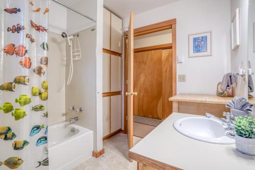 a bathroom with a sink and a shower at Driftwood Cottage MCA 491 - Meredith Lodging in Manzanita