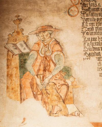 a painting of a man with a dog on a table at Hotel Copernicus in Kraków