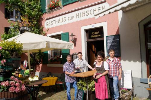 a group of people standing in front of a restaurant at Gasthaus Zum Hirschen in Staufen im Breisgau