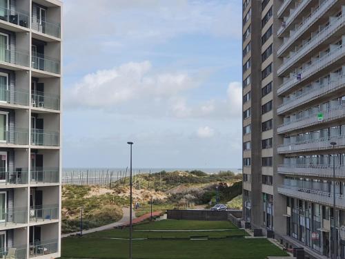 a view of the beach from between two buildings at Oostduinkerke Apartments in Oostduinkerke