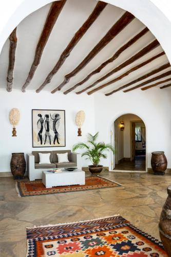a living room with a couch and a rug at Lion in the Sun Boutique Hotel & Spa in Malindi