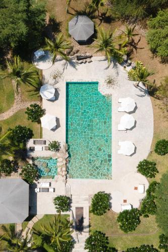 an overhead view of a swimming pool with umbrellas at Lion in the Sun Boutique Hotel & Spa in Malindi
