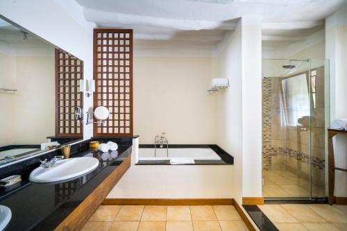 a bathroom with a sink and a shower at Lion in the Sun Billionaire Retreat Malindi in Malindi
