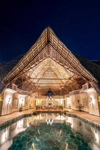 a large swimming pool in front of a building at Lion in the Sun Boutique Hotel & Spa in Malindi