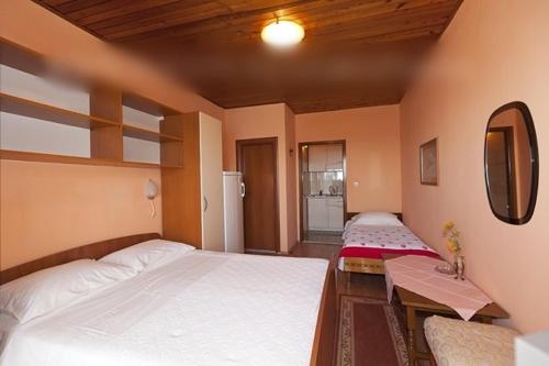 a bedroom with two beds and a table and a mirror at Studio apartment in Tucepi with sea view, balcony, air conditioning, WiFi 3674-4 in Tučepi
