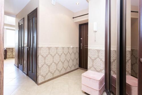 a walk in shower room with a pair of pink stools at Kvartiras Minsk Apartments in Minsk