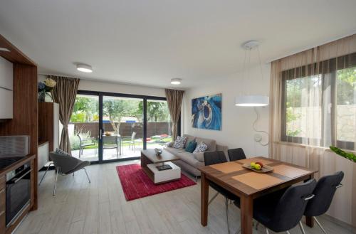 a living room with a table and a couch at Villa Marija in Sveti Filip i Jakov