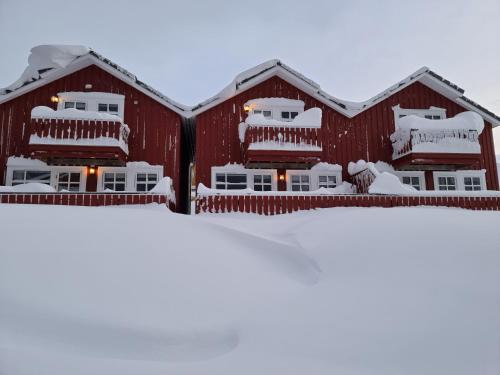 a red barn covered in snow at Kjerringøy Bryggehotell in Bodø