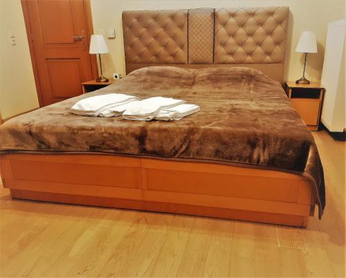 a bed with two white pillows on top of it at Archontiko Evridikis in Vitsa
