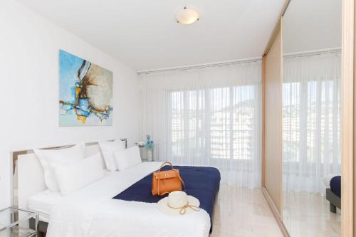 une chambre avec un lit avec un sac orange dessus dans l'établissement On la Croisette fabulous sea view 1 bed, à Cannes
