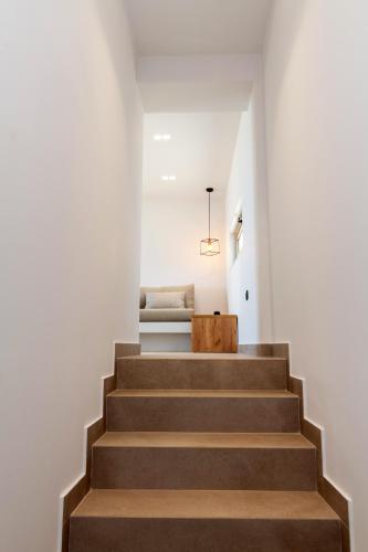 a staircase leading to the second floor of a house at Blue Gres Villa Tinos in Tinos Town