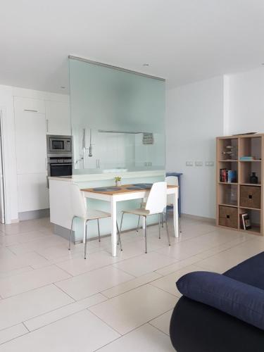 a kitchen with a table and chairs in a room at Apartment Tenerife Sur in Palm-Mar