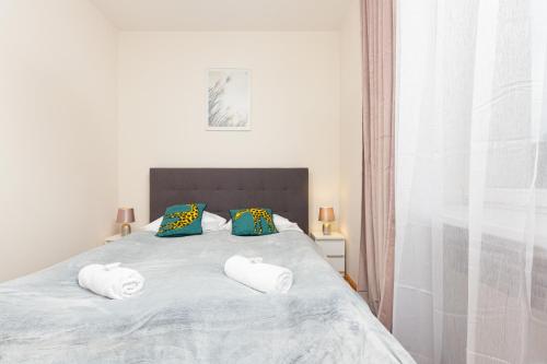 a bedroom with a bed with two pillows on it at City Center Apartment Elektoralna by Renters in Warsaw