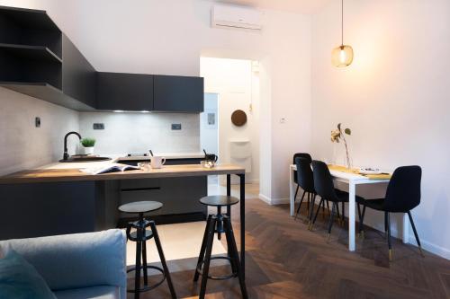 a kitchen and living room with a table and chairs at Modern and Design Apartment near the Main Square in Zagreb