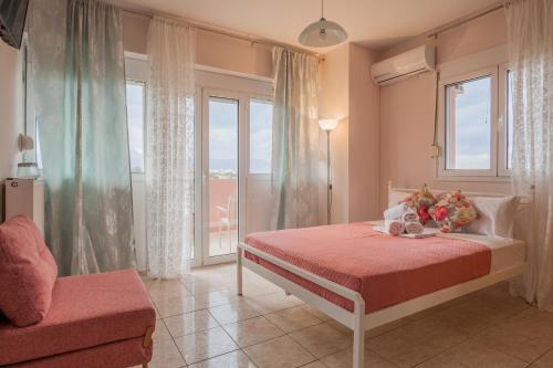 a bedroom with a bed and a window at Faidra 03 at TEI in Heraklio