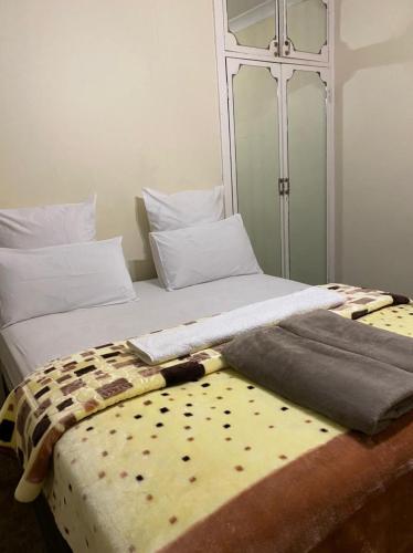 a bed with a blanket on it with at 26 Zea avenue Arcon Park Guest House in Vereeniging