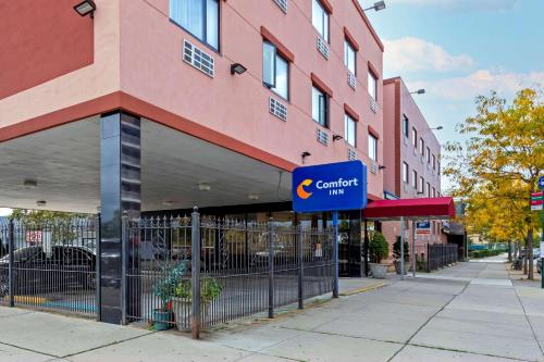 a building with a sign for a car dealership at Comfort Inn Brooklyn in Brooklyn