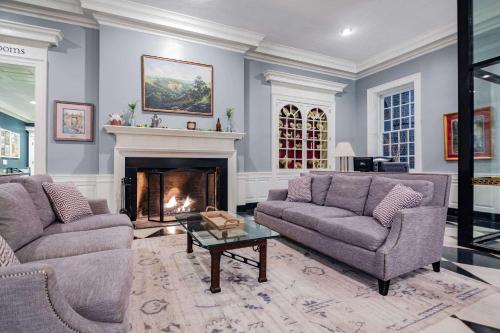 a living room with two couches and a fireplace at Natural Bridge Hotel, Trademark Collection by Wyndham in Natural Bridge