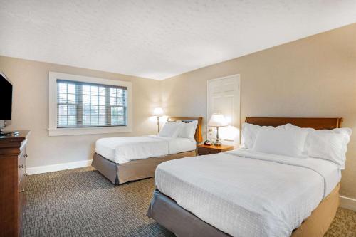 a hotel room with two beds and a window at Natural Bridge Hotel, Trademark Collection by Wyndham in Natural Bridge