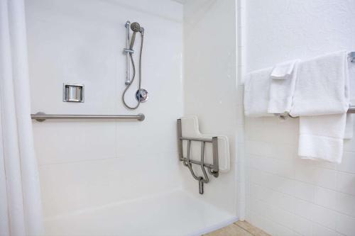a bathroom with a shower with white towels at Natural Bridge Hotel, Trademark Collection by Wyndham in Natural Bridge